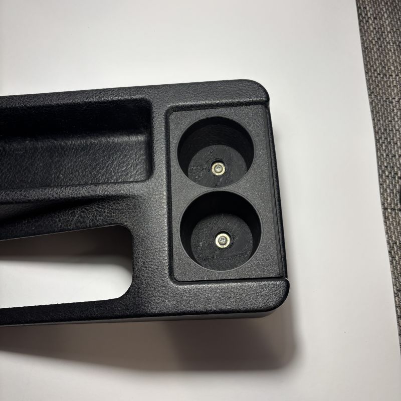 BMW E36 Rear Dual Cupholder v1 placed on table with screws inside