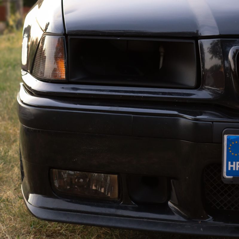 BMW E36 Headlight Air Intake installed, close-up detail